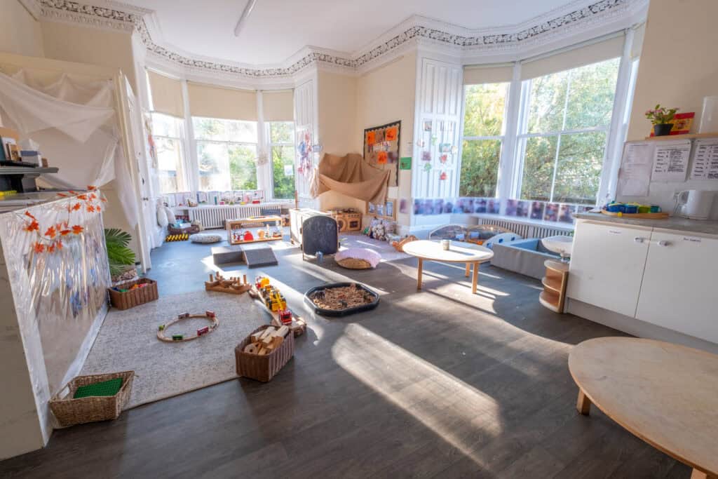 Bright and welcoming indoor childcare playroom with large windows, natural light, and age-appropriate toys, perfect for nurturing early childhood development and early learning activities.