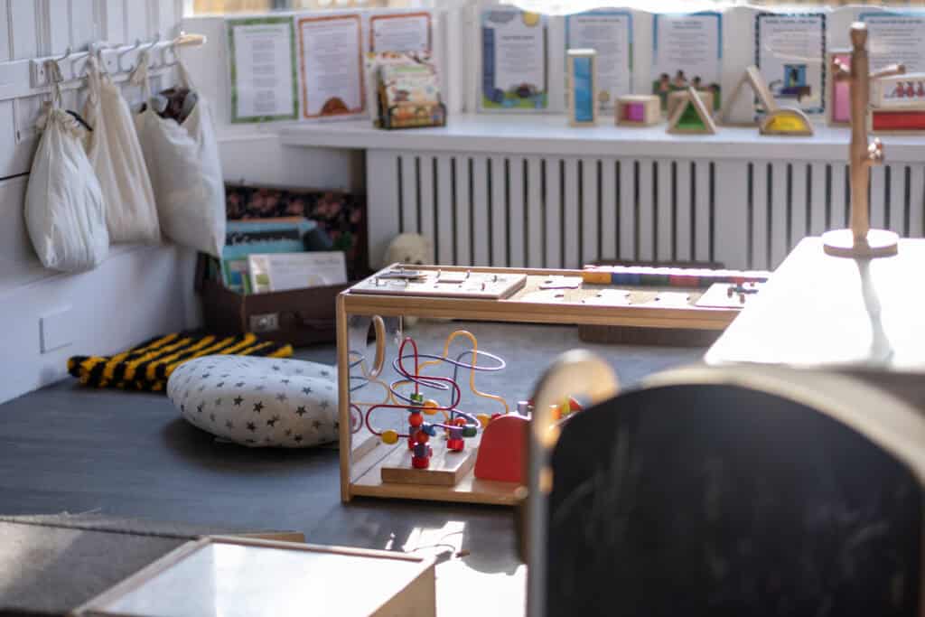 Bright and inviting Thrive Childcare indoor play area with educational toys, books, and cosy seating, fostering learning and creativity for young children.