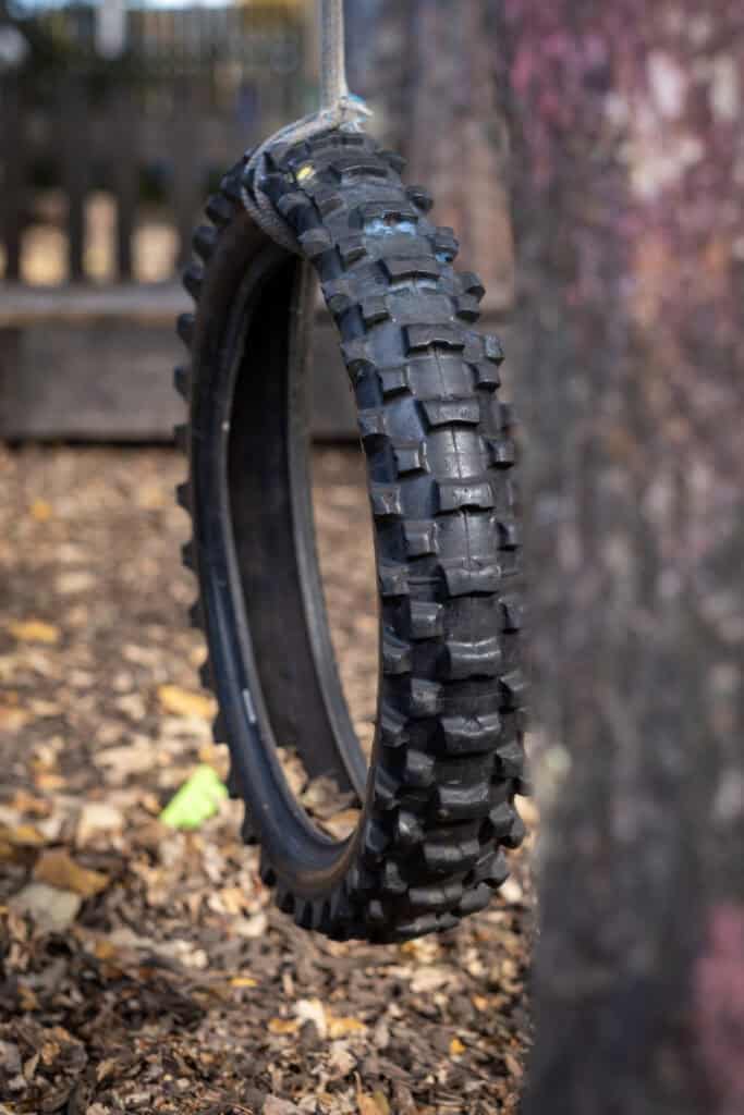 Climbing tire swing equipment for outdoor children's playground at Thrive Childcare, promoting active play and outdoor adventure for kids in a safe, supervised environment.