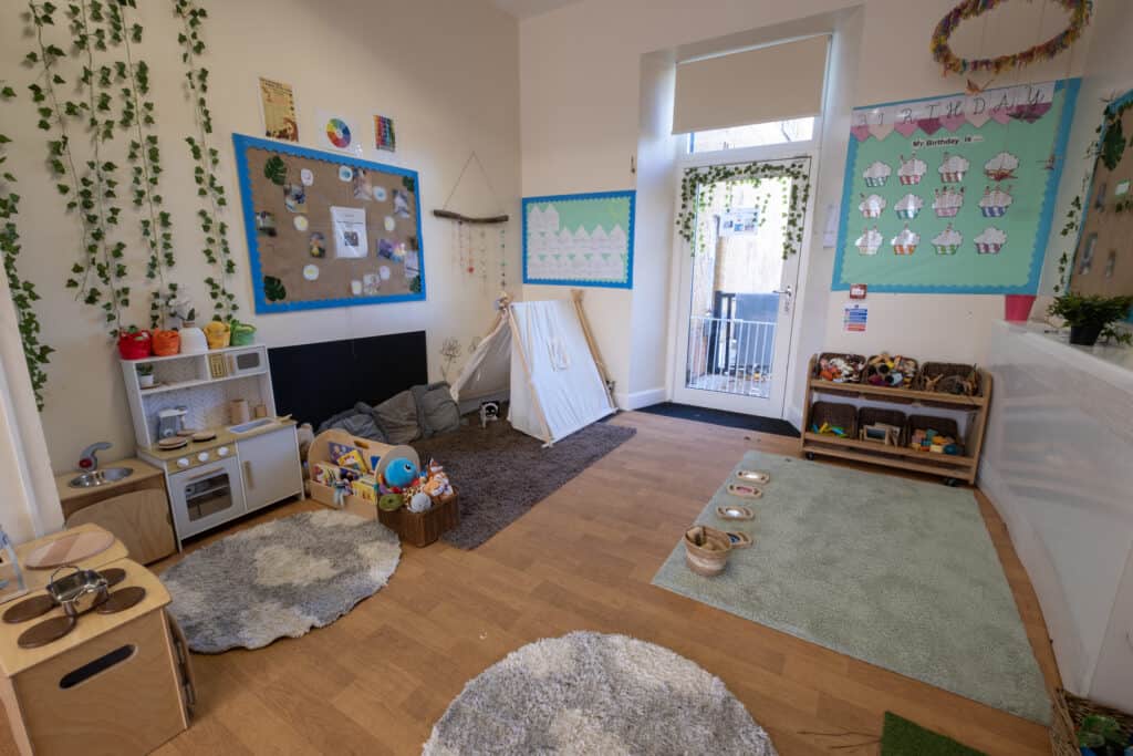 Bright and welcoming childcare classroom with educational wall displays, toys, and play areas, dedicated to nurturing early childhood development at Thrive Childcare in a safe, engaging environment.