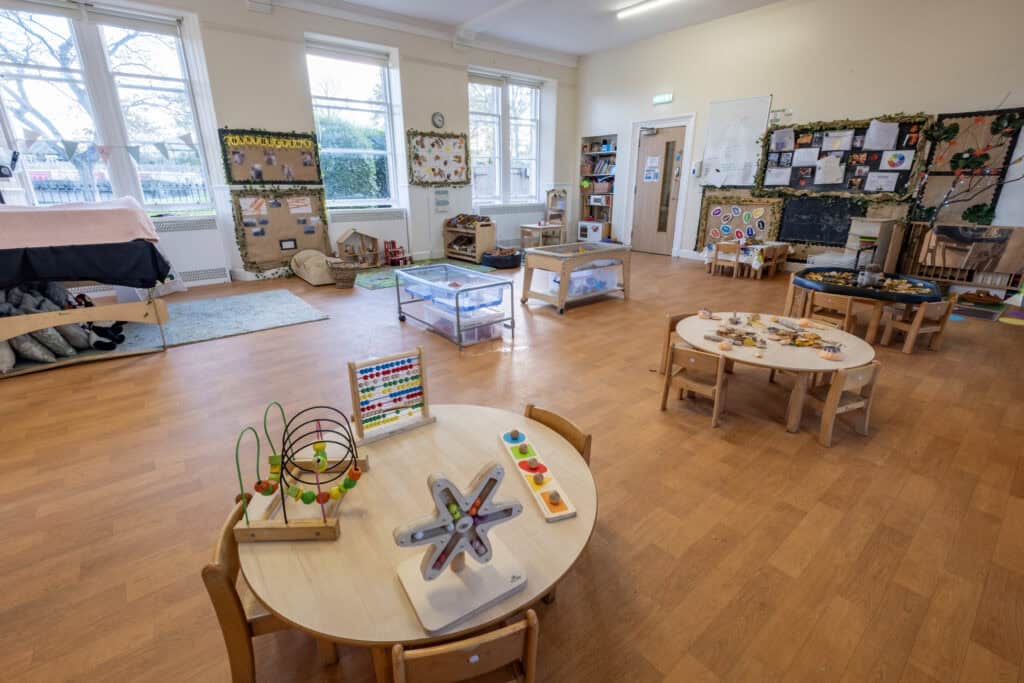 Bright, welcoming childcare nursery classroom with spacious play areas, educational toys, and colourful displays, designed to support early childhood development and learning at Thrive Childcare.