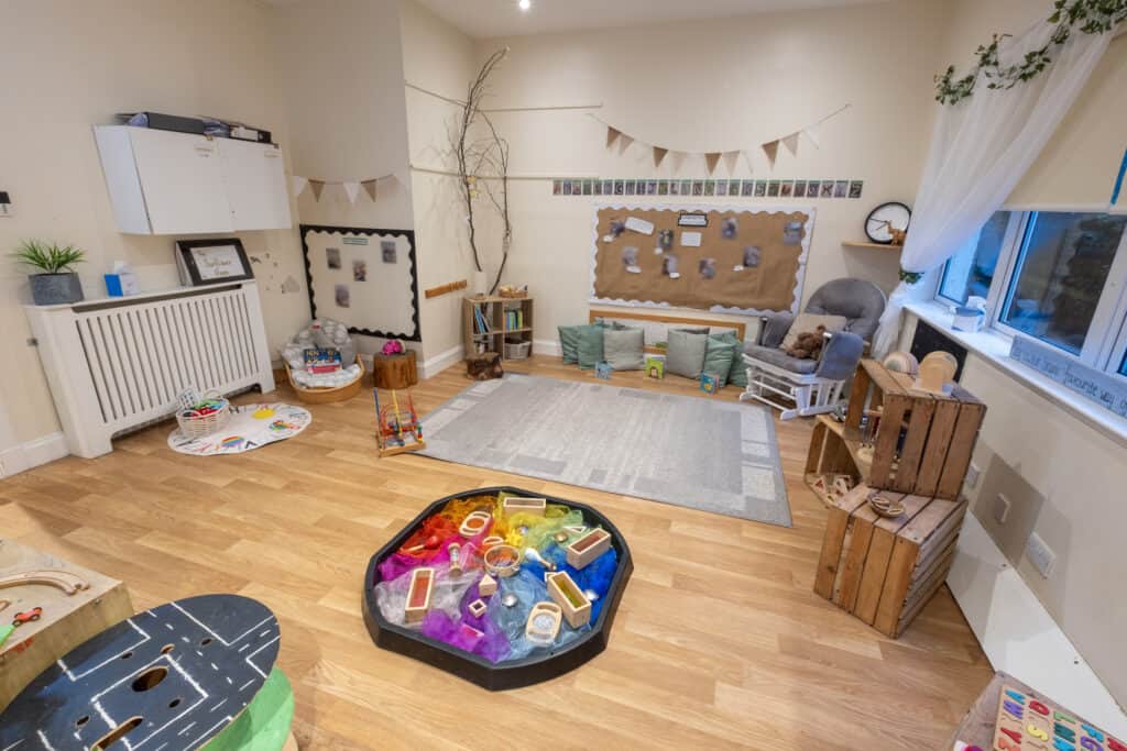 Bright, welcoming childcare playroom with age-appropriate toys, soft cushions, and learning resources, creating a safe and engaging environment for young children at Thrive Childcare.