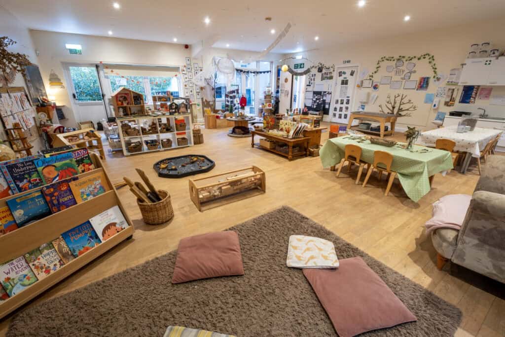 Bright and colourful Thrive Childcare indoor play area with educational toys, art stations, reading corner, and cosy seating, designed for early childhood development and nurturing learning environments.