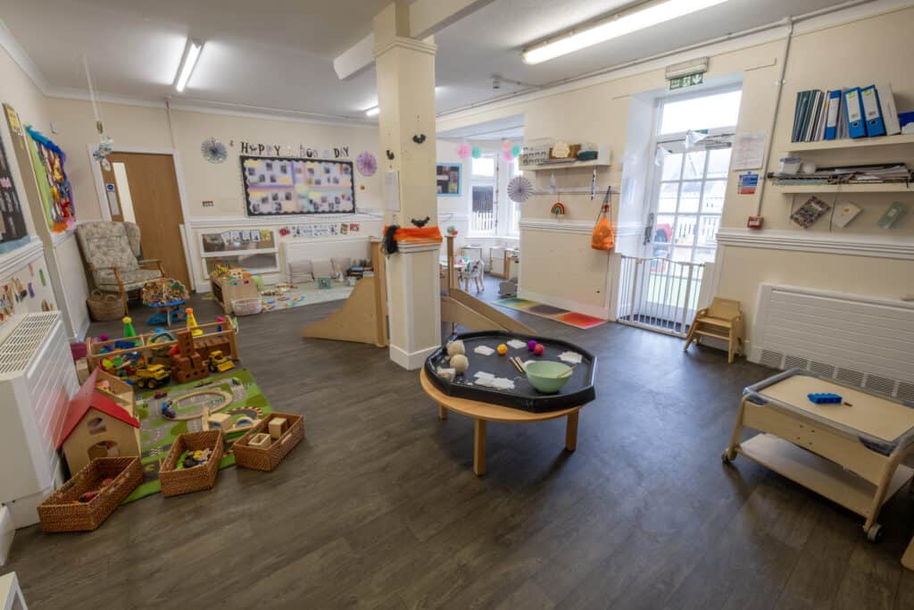 Bright childcare indoor play area at Thrive Childcare with toys, play structures, and learning materials promoting child development and early education.