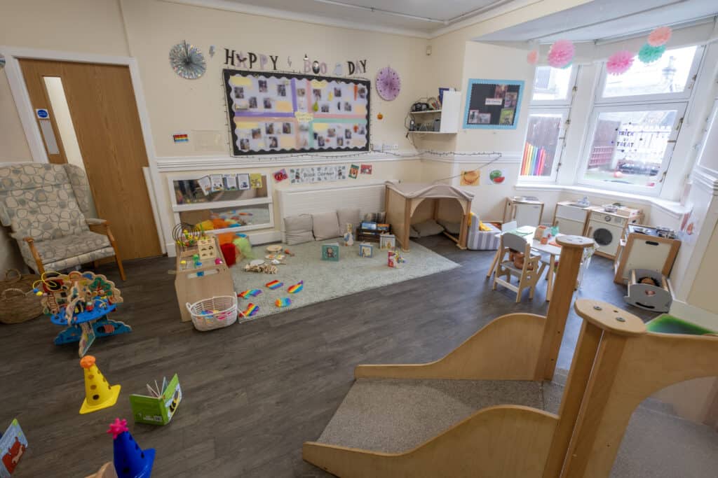 Bright and welcoming childcare indoor play area with toys, cosy corners, and colourful decorations at Thrive Childcare, designed to promote learning and fun for young children.