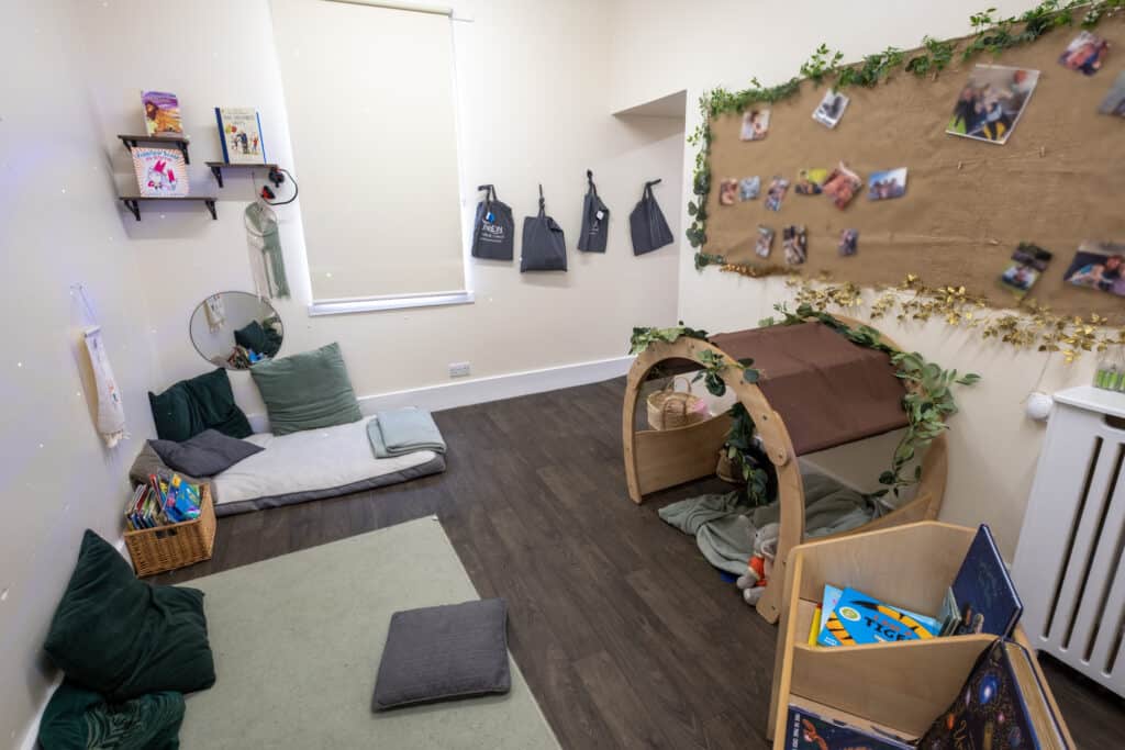 1. Comfortable indoor children’s playroom with cozy cushions, books, and a sensory area at Thrive Childcare for early childhood development and learning.