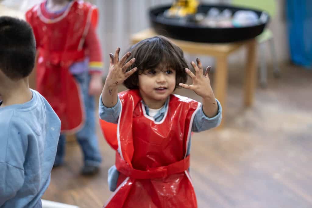 Colourful young children engaging in creative activities at Thrive Childcare nursery, encouraging early childhood development and play-based learning in a safe, nurturing environment.