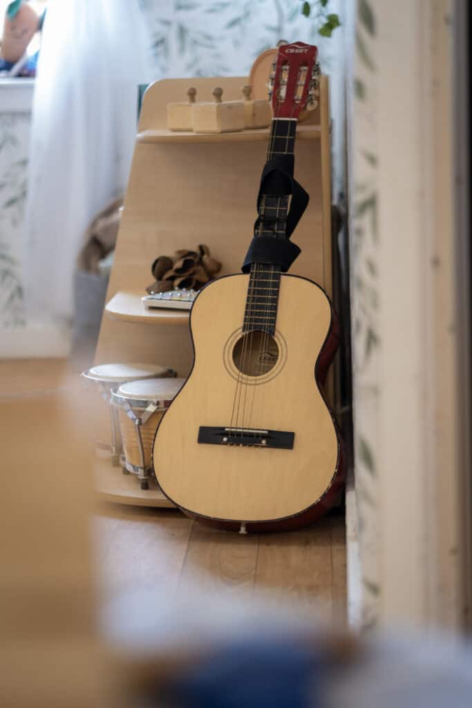 Playing guitar and music instruments in a childcare setting at Thrive Childcare, fostering creativity and musical development in young children.
