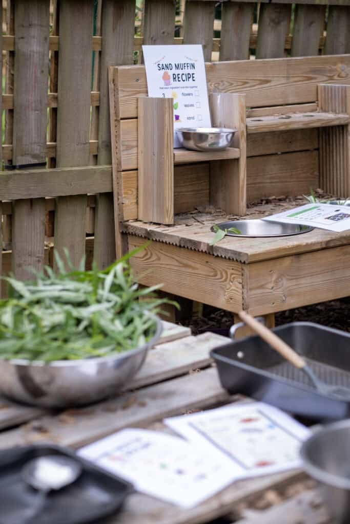 Sand muffin recipe outdoor activity for children at Thrive Childcare, focusing on sensory play and early learning. Safe, engaging environment for preschoolers to explore cooking and nature.