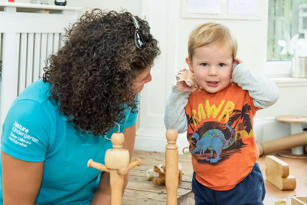 Bright, happy young boy playing with a care worker at Thrive Childcare, promoting early childhood education and nurturing environments for children.