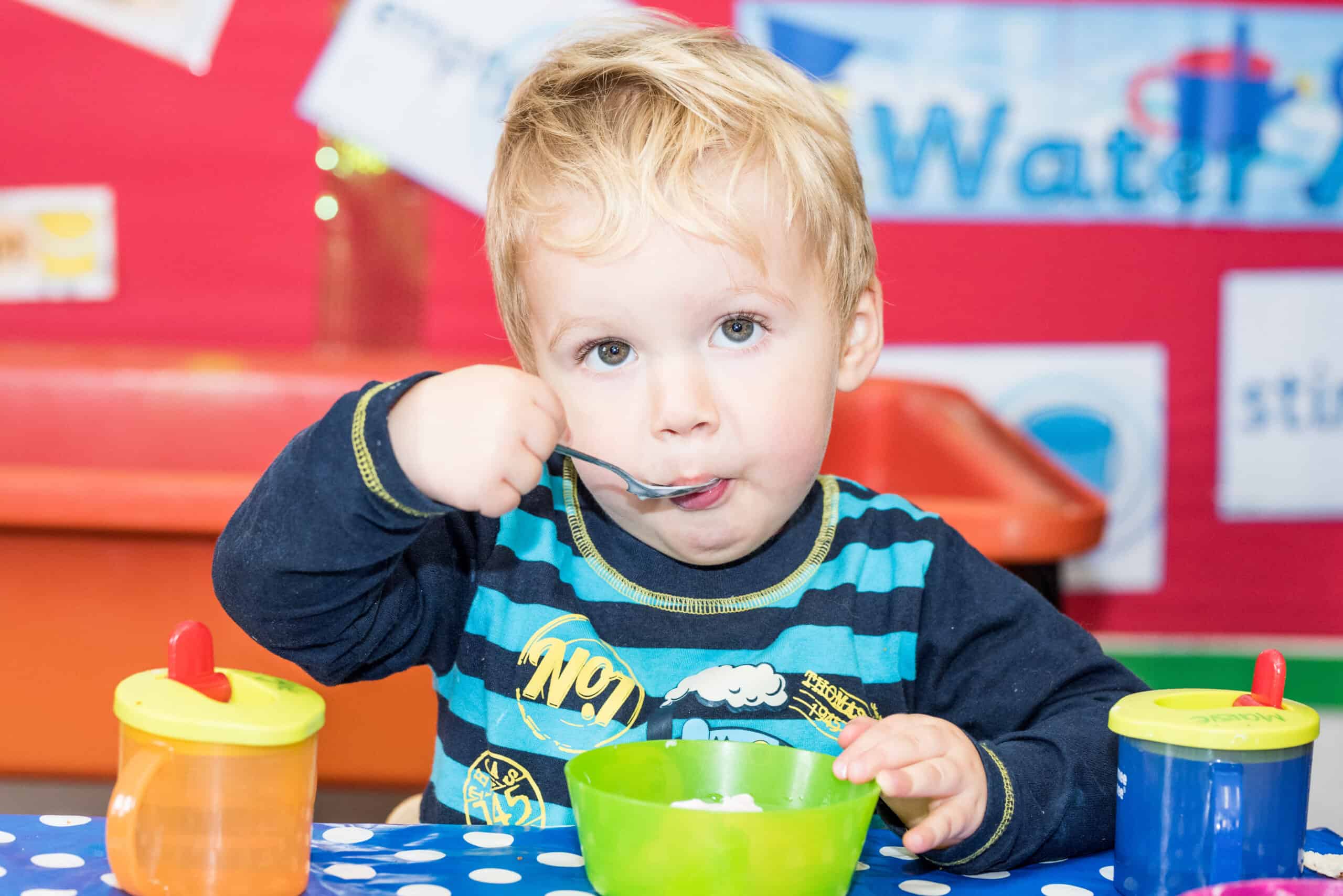 1.Young child eating at Thrive Childcare, engaging in early childhood development activities, promoting a nurturing environment for children’s growth and learning.