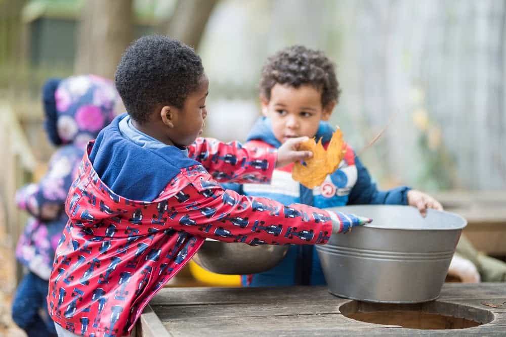 Children playing outdoors at Thrive Childcare, engaging in sensory and educational activities, fostering development in a safe and nurturing environment.