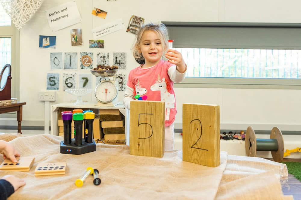 Colourful educational toys and children engaging in learning activities at Thrive Childcare, fostering early childhood development and numeracy skills.