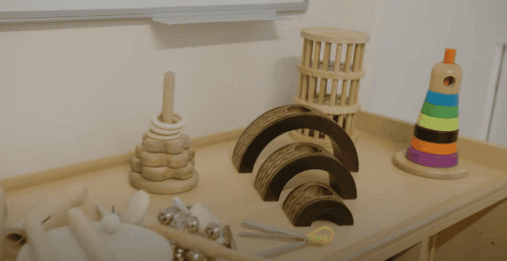 Bright wooden sensory toys on a child's play table at Thrive Childcare, promoting early development, fine motor skills, and sensory exploration for kids in a safe and nurturing environment.