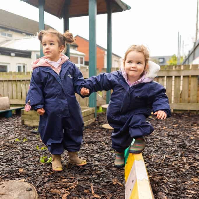 Playing outdoors at Thrive Childcare in a safe and nurturing environment, encouraging social development and physical activity for young children.