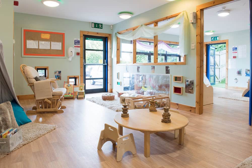 Bright, welcoming childcare room at Thrive Childcare with natural light, child-friendly furniture, colourful decor, and educational toys promoting early childhood development and learning.