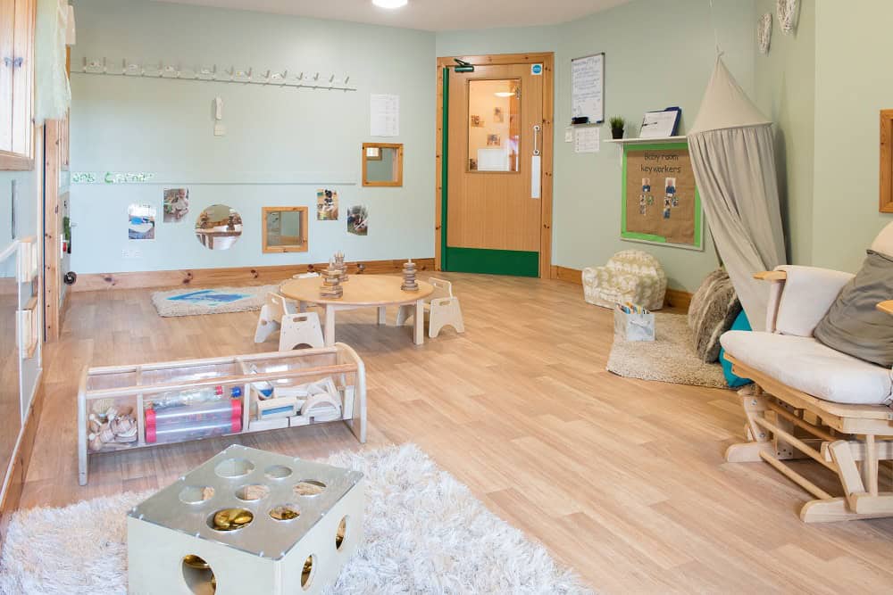 Bright nursery room at Thrive Childcare with cosy seating, age-appropriate toys, and engaging learning spaces for early childhood development in a nurturing environment.