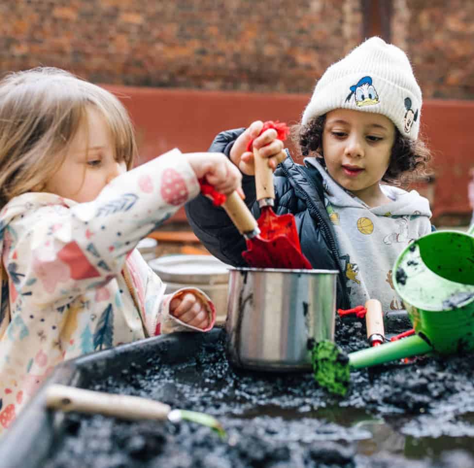 Children engaging in outdoor sensory play with water and toys at Thrive Childcare, promoting early childhood development and hands-on learning for preschoolers.