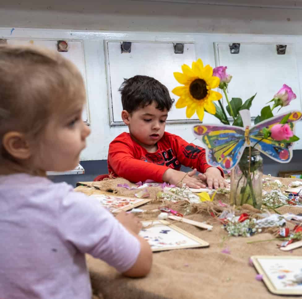 Bright young children engaging in creative activities at Thrive Childcare, showcasing a nurturing environment for early childhood development and learning. A colourful setting designed for preschool education.