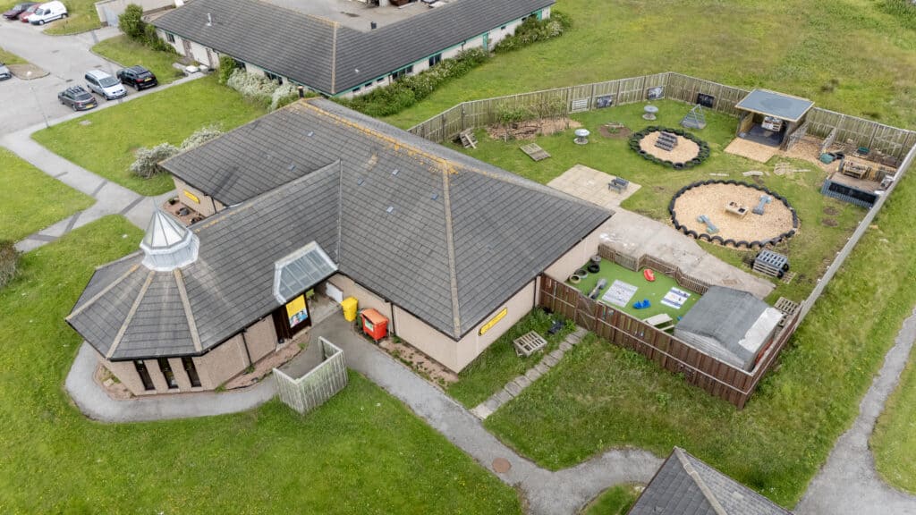 Bright outdoor play area at Thrive Childcare with sandpits, climbing equipment, and seating for children’s activities and outdoor learning.