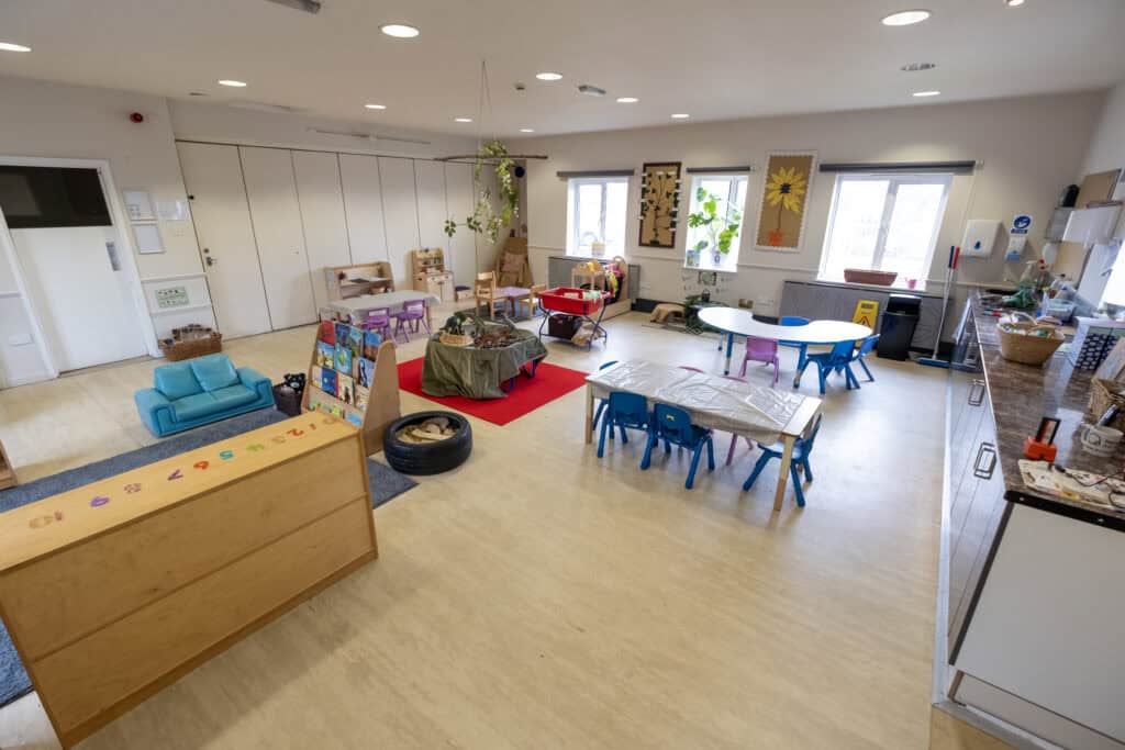 Bright, welcoming nursery playroom at Thrive Childcare with engaging toys, colourful furniture, and natural light, fostering a safe and nurturing environment for early childhood development.