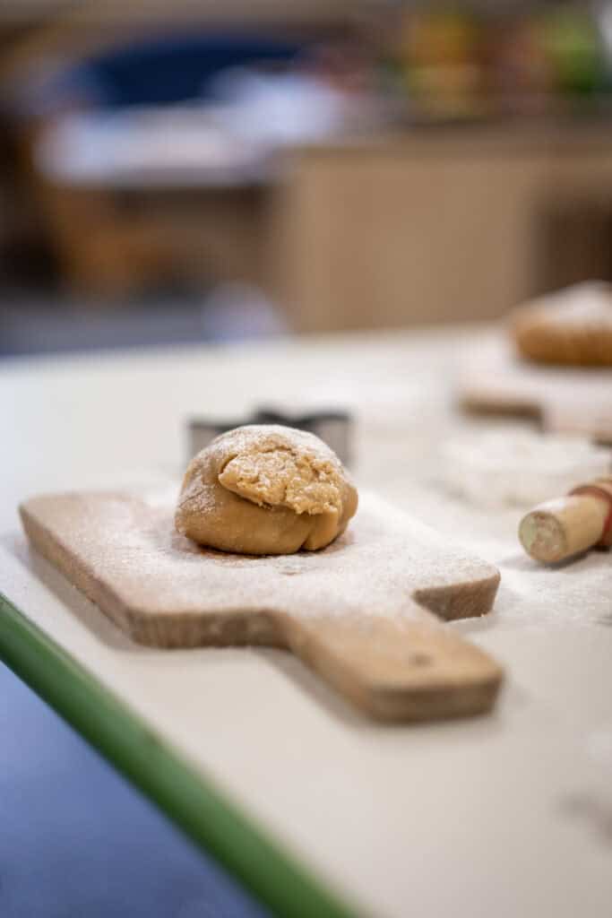 Creamy cookie dough on a wooden baking board at Thrive Childcare, highlighting early childhood cooking activities.