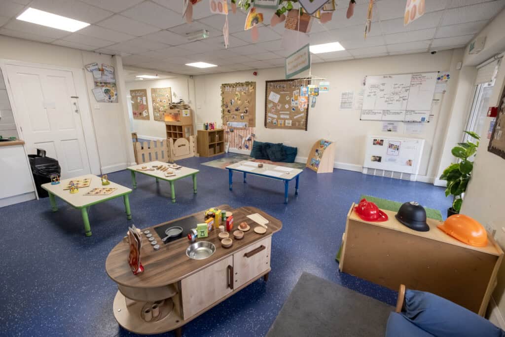 Bright and welcoming indoor childcare space at Thrive Childcare, featuring engaging play areas, educational posters, and safe environments designed for early childhood development and learning.