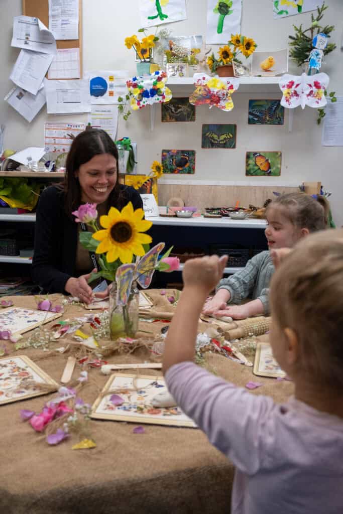 Sunflower craft activity with children at Thrive Childcare, fostering creativity and sensory development in a colourful classroom environment.