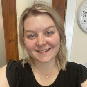 Bright smiling childcare staff member at Thrive Childcare, providing nurturing early childhood education and care in a friendly environment.