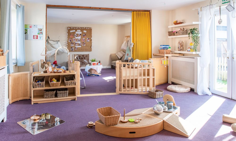 Bright, toddler-friendly childcare room with wooden furniture, soft toys, and sensory play areas, ideal for early childhood development and safe exploration at Thrive Childcare.