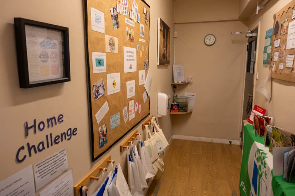 1. Bright nursery hallway at Thrive Childcare with colourful displays and activity bags, creating an engaging environment for young children and parents.