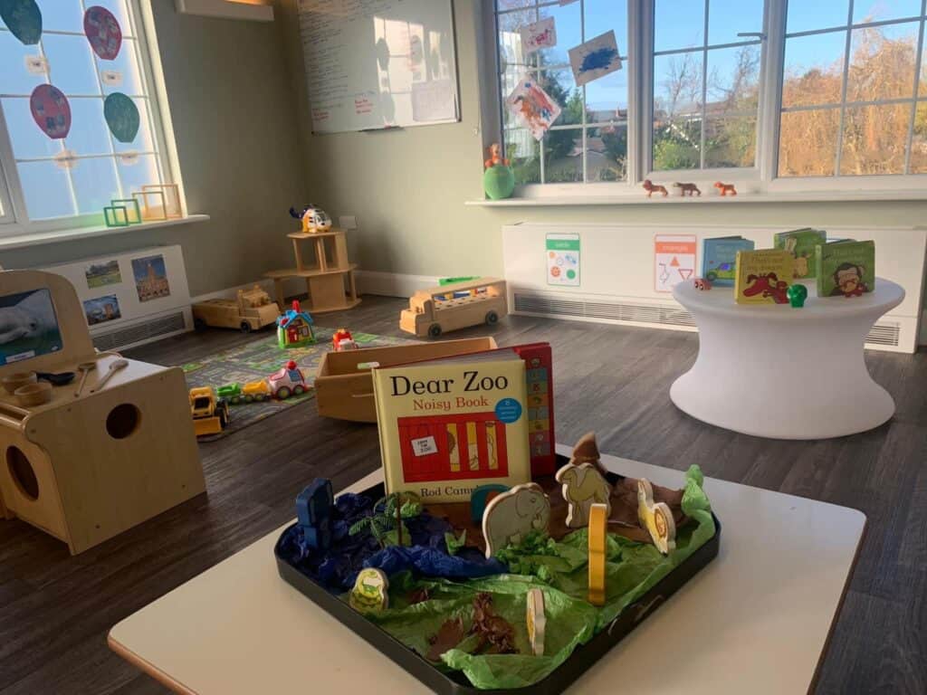 Colorful indoor childcare play area with toys, books, and educational materials at Thrive Childcare, promoting early childhood development and learning in a safe, engaging environment.