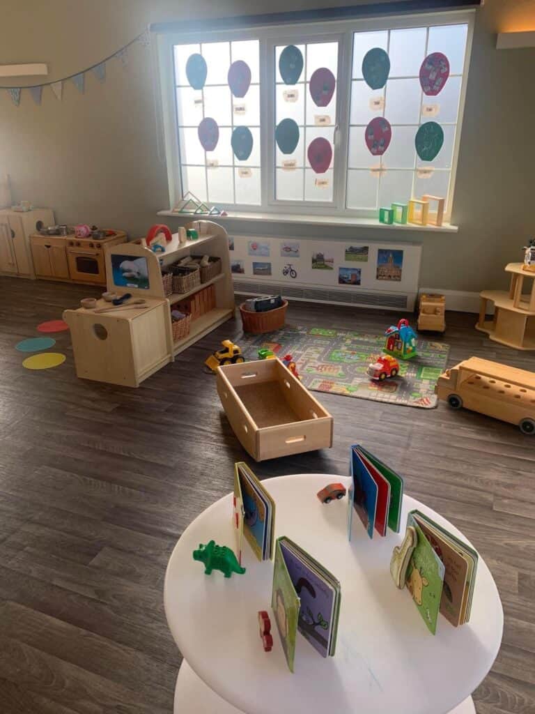 1. Bright and spacious child-friendly playroom with toys, books, and educational activities at Thrive Childcare center.