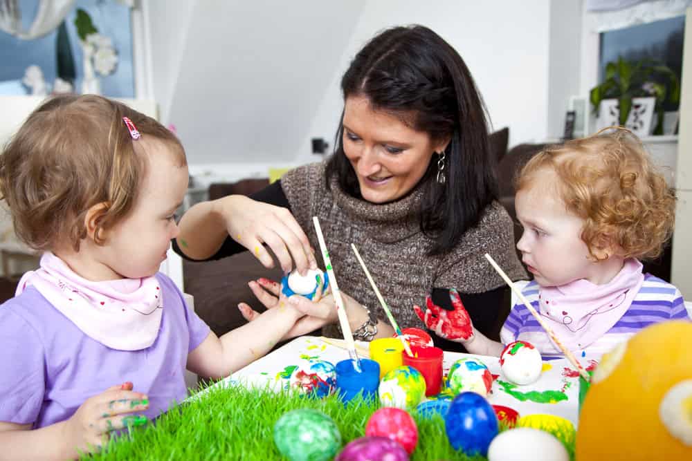 Brightly coloured Easter eggs and children enjoying playful arts and crafts activity at Thrive Childcare, showcasing a happy, engaging nursery environment.