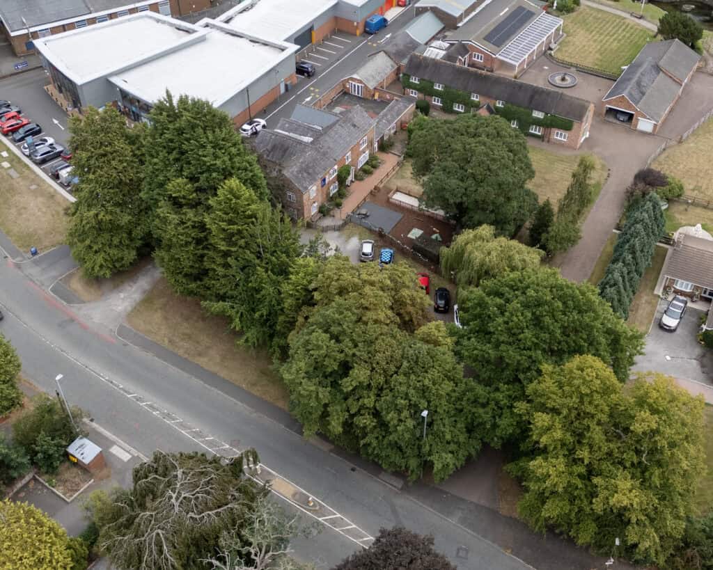 Colorful childcare facility with a spacious outdoor play area, surrounded by greenery, located in a residential neighbourhood. A perfect environment for early childhood development and learning.