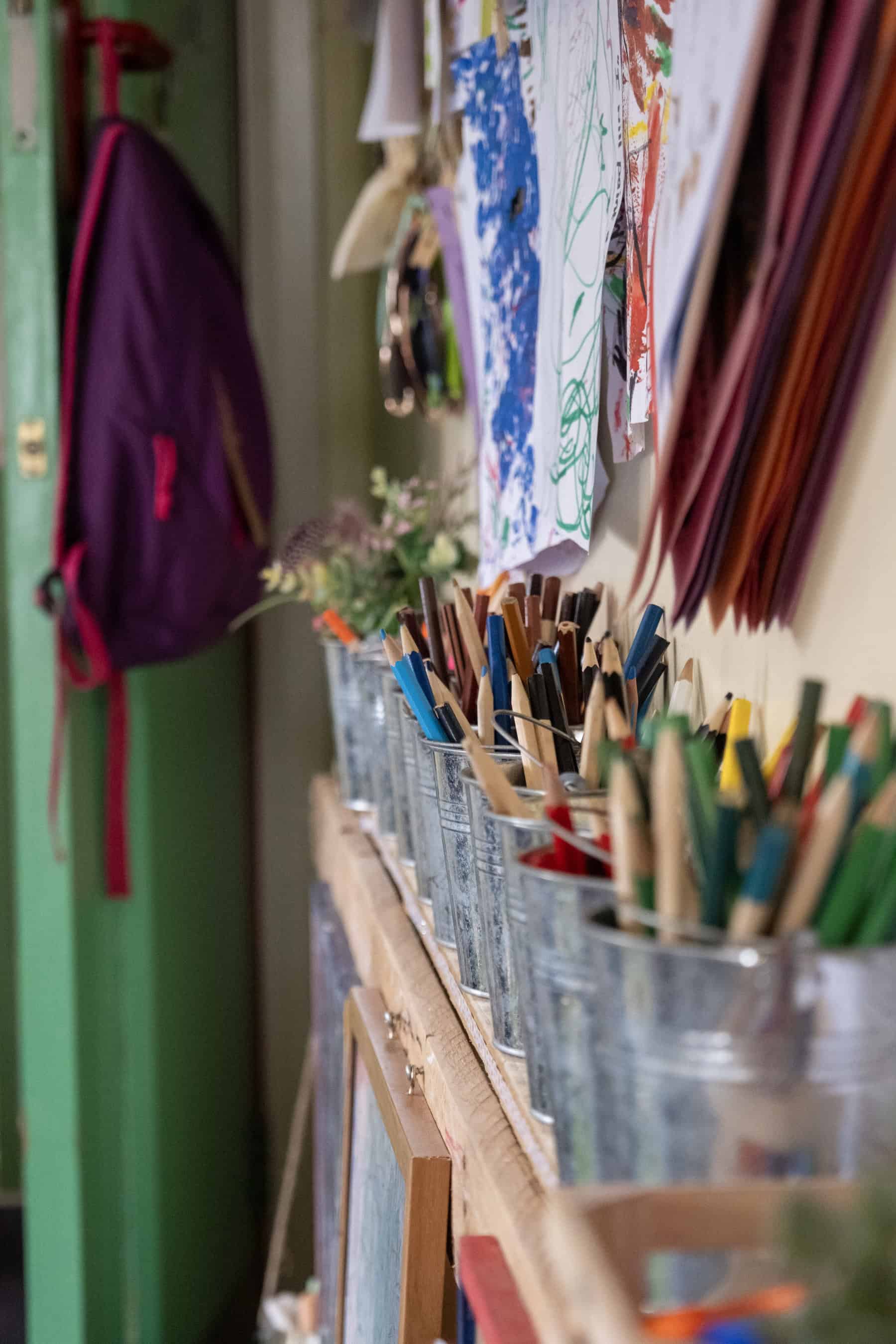 Colourful art supplies and children's drawings on display at Thrive Childcare, fostering creativity and early development in a nurturing environment.