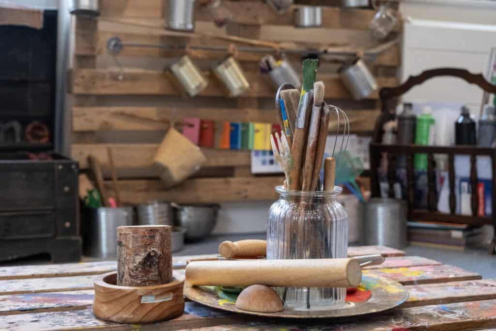 Bright children's arts and crafts supplies in a colourful, creative toddler activity area at Thrive Childcare centre.