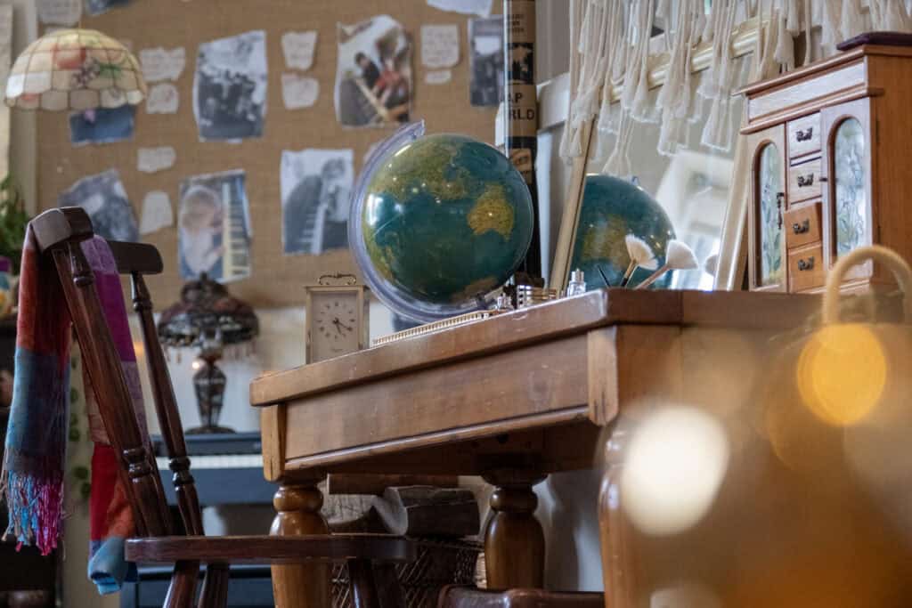 Brightly coloured globe on wooden desk, educational childcare environment with learning resources and decor for children at Thrive Childcare facility.