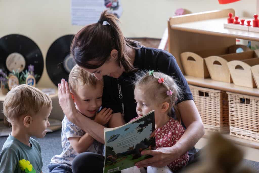 Engaging childcare scene with teacher reading story to children, fostering early learning and development at Thrive Childcare.
