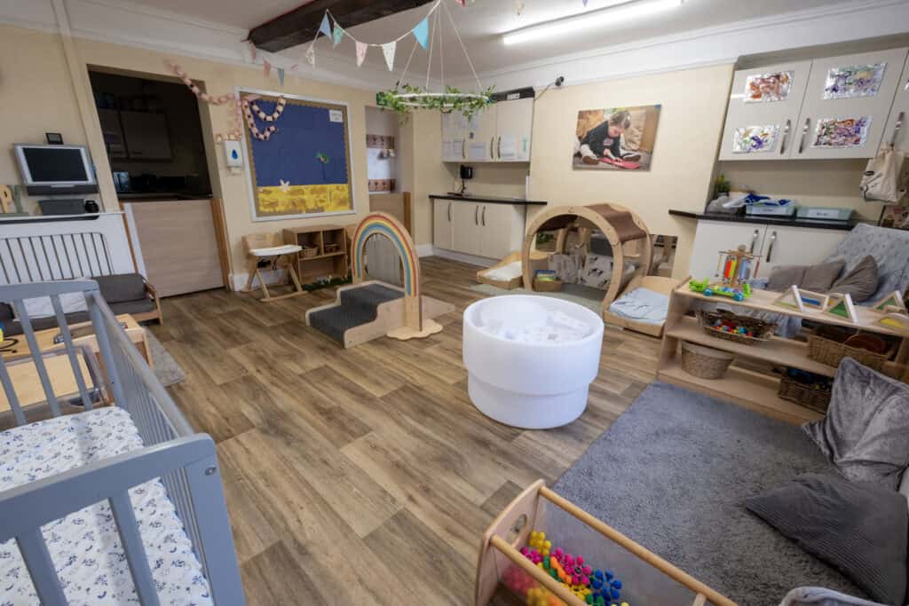 Bright and inviting Thrive Childcare indoor playroom with age-appropriate toys, comfy seating, and colourful decorations promoting early childhood development and safe learning environments.