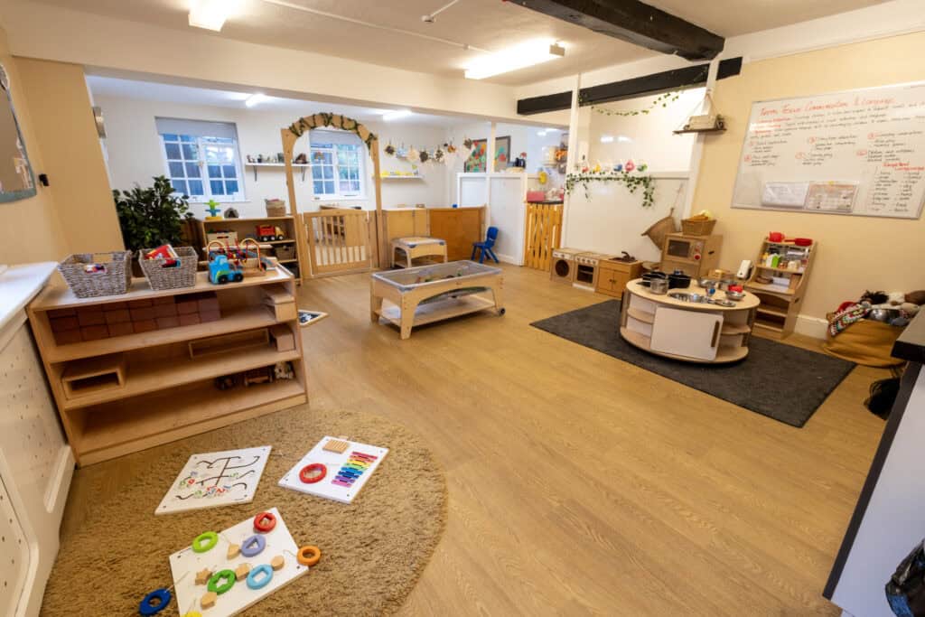 Bright and inviting childcare playroom at Thrive Childcare featuring wooden toys, sensory activities, and learning stations designed for early childhood development and fun.