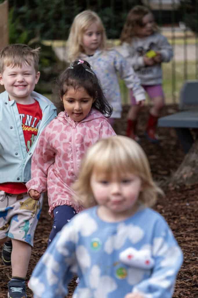 Children playing outdoors at Thrive Childcare, engaging in supervised activities and outdoor learning. A safe, nurturing environment promotes early childhood development and social skills.