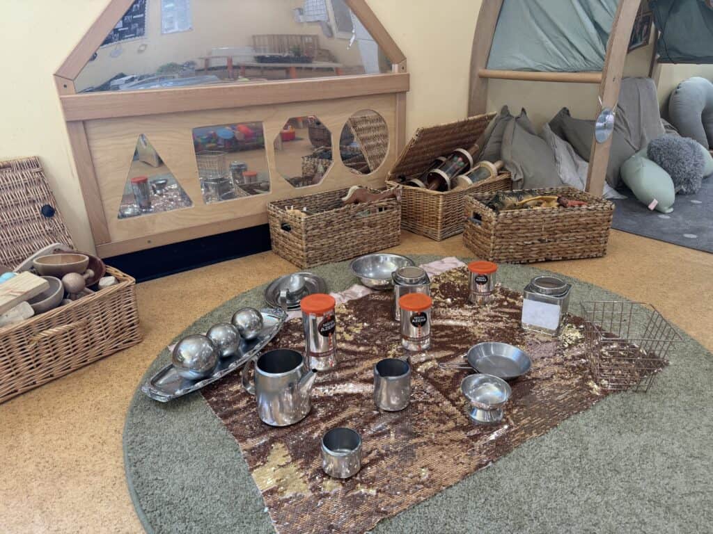 1. Wicker baskets with children's toys and natural wooden play structures in a warm childcare centre.