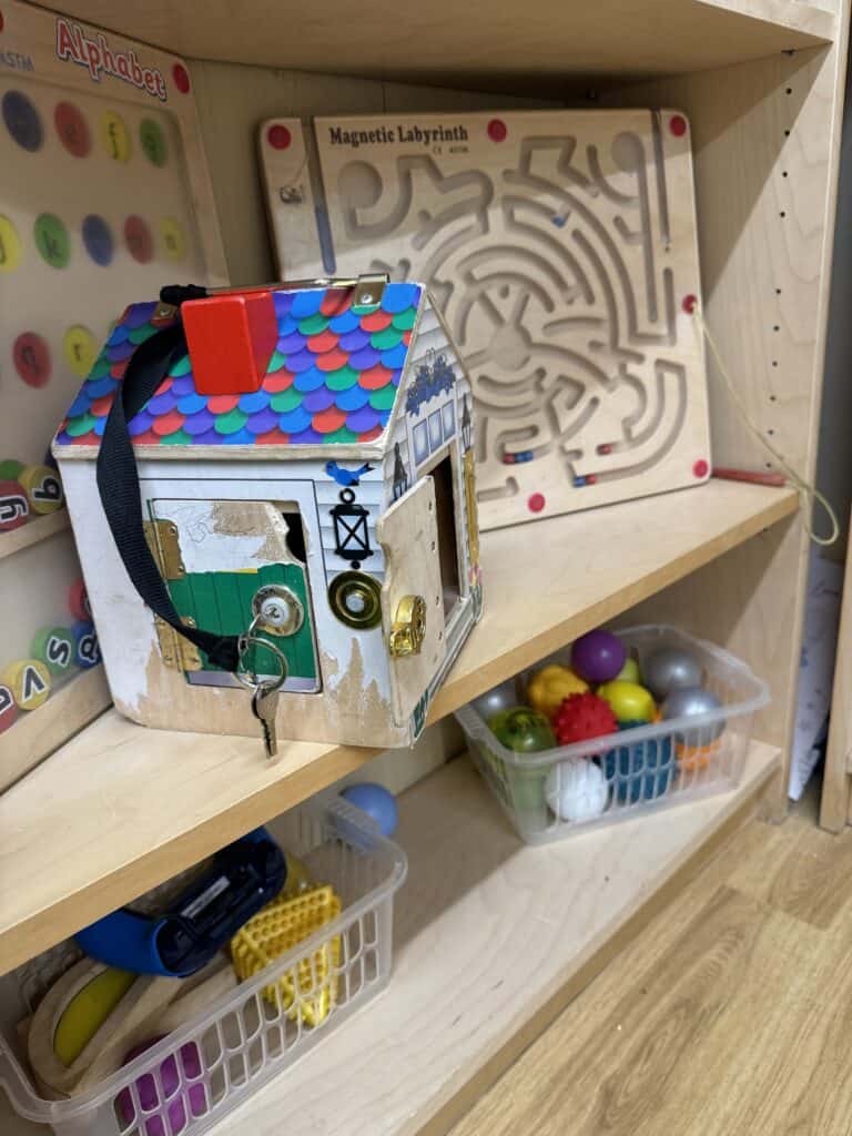 Bright, colourful learning toys and educational games for children at Thrive Childcare, including a maze, magnetic labyrinth, and sensory balls, promoting early childhood development and play-based learning.