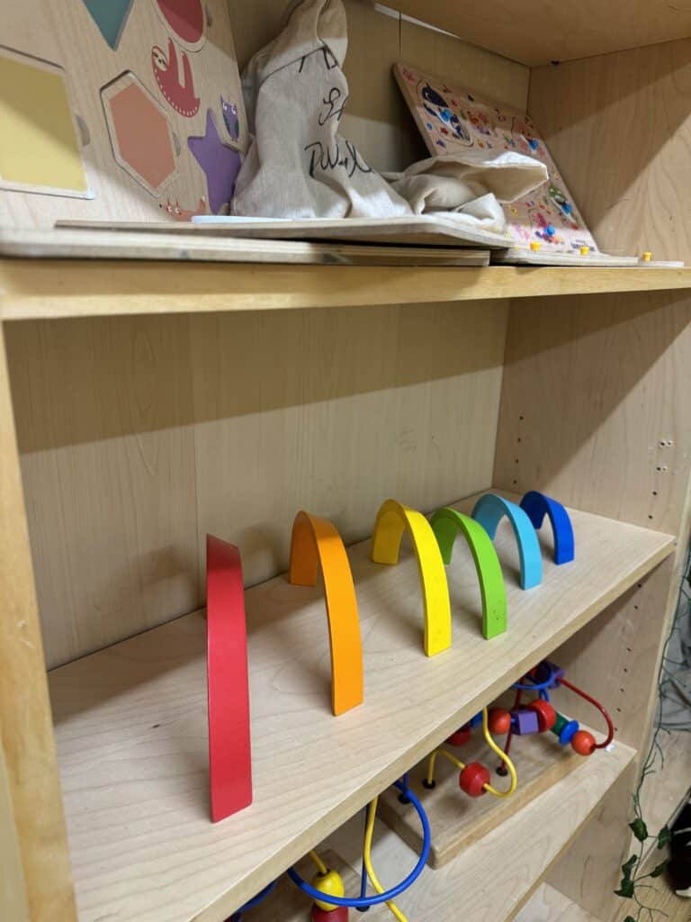 Bright children's toys and educational items at Thrive Childcare, including colourful wooden arches and engaging learning tools for preschool development and early childhood education.