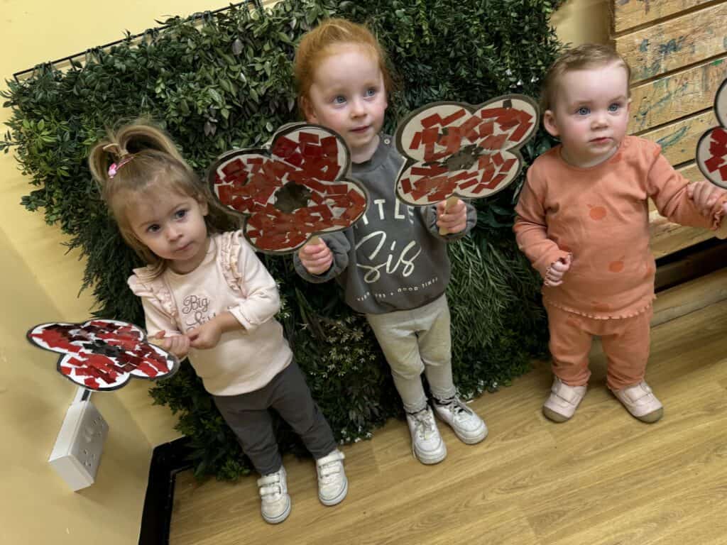 Bright young children holding handmade butterfly crafts at Thrive Childcare, showcasing engaging early childhood education and creative activities for preschoolers.