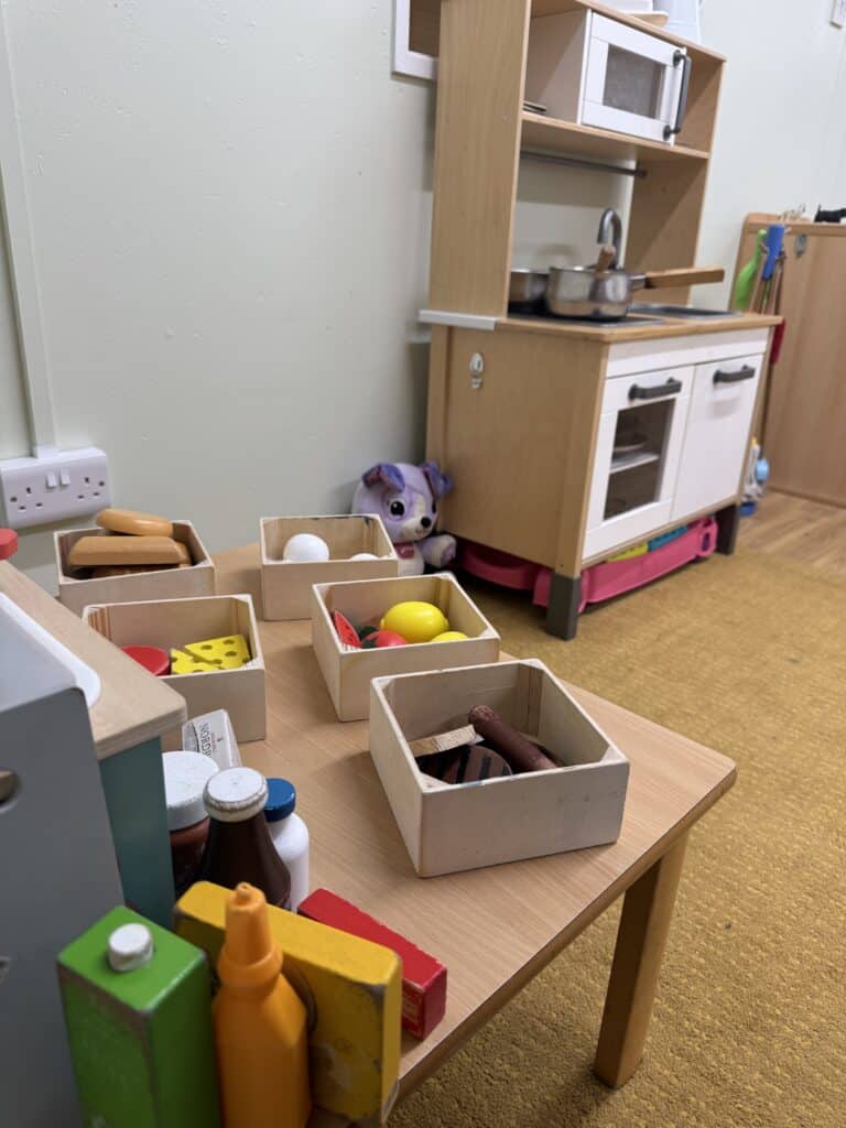 Miniature toy food and kitchen playset for kids at Thrive Childcare, fostering imaginative play and early learning in a safe, nurturing environment. Perfect for preschool children’s development.