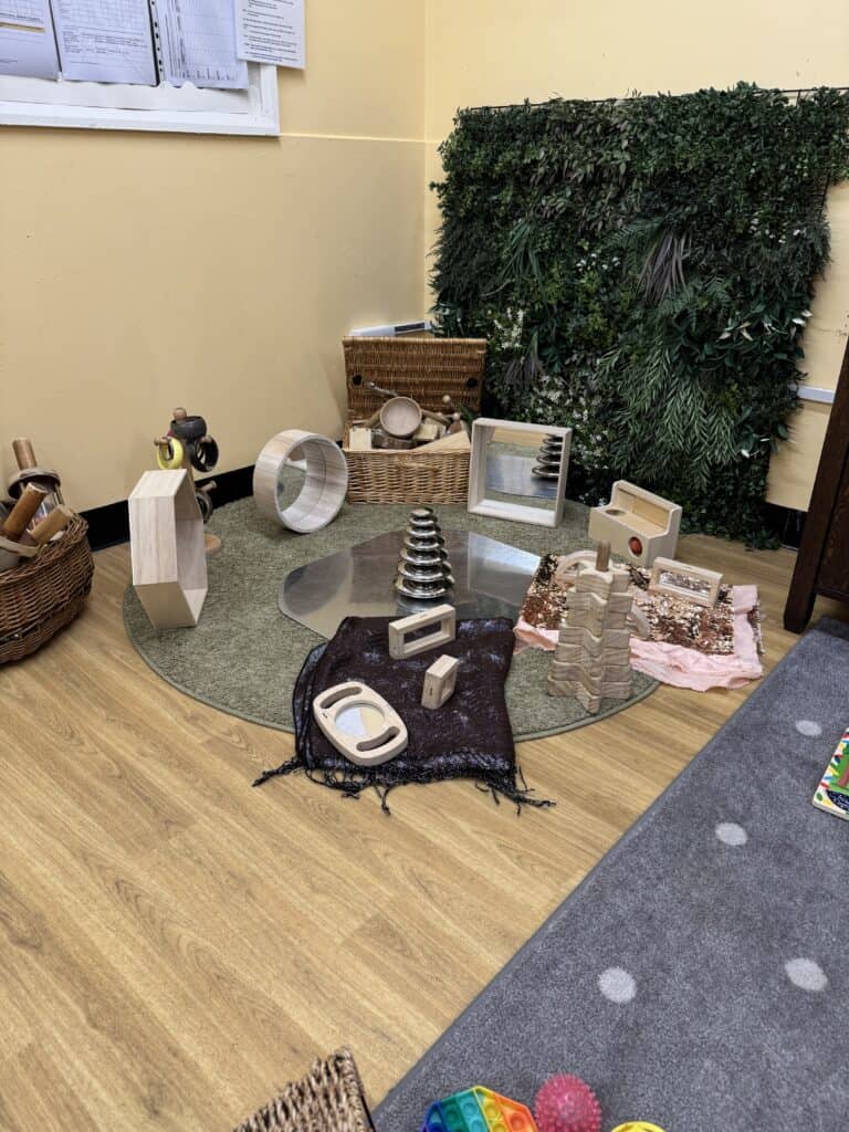 Fashioned sensory play area with natural wooden toys, climbing blocks, and tactile activities for children’s development at Thrive Childcare.