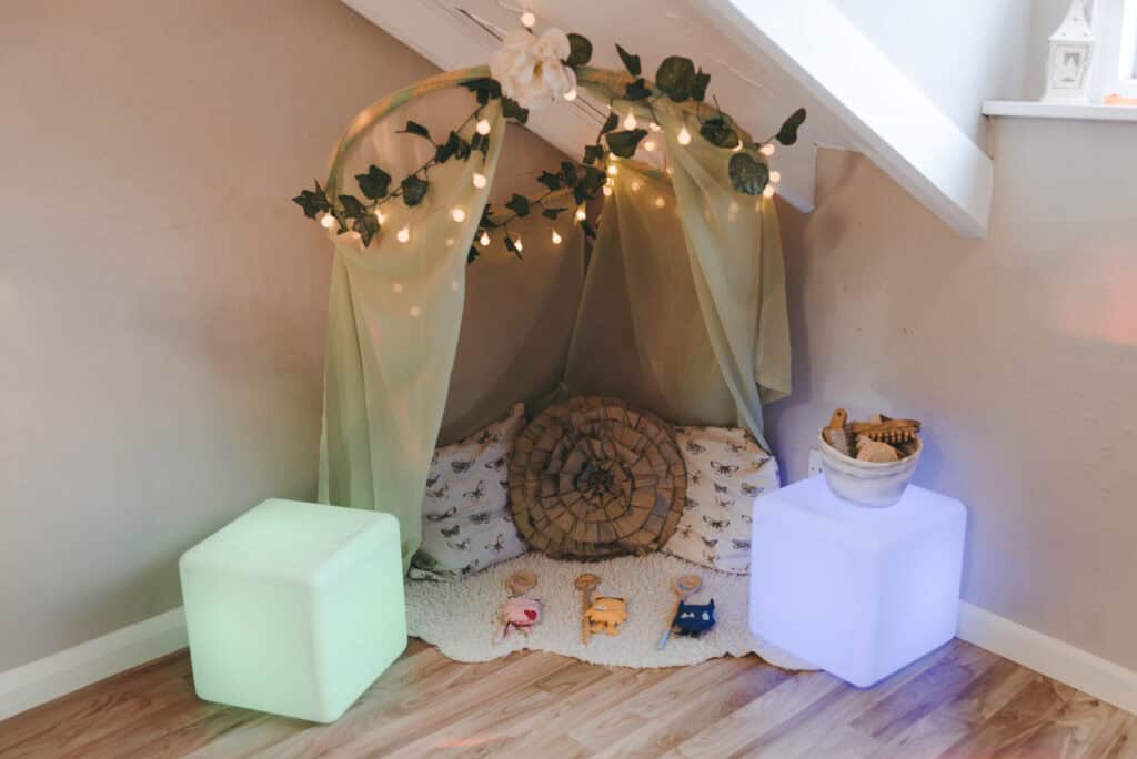 Cozy children's play area with soft lighting, fairy lights, and decorative canopy in a safe indoor setting perfect for early childhood development and play at Thrive Childcare.