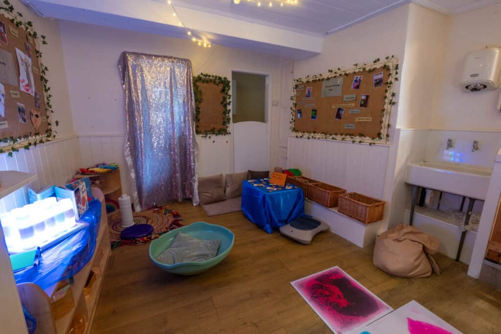 Bright indoor play area at Thrive Childcare with cozy cushions, sensory toys, and colourful decor, fostering safe and stimulating environments for children's development and early learning.